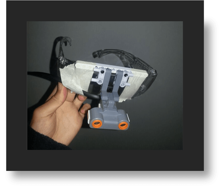 The first mockup: a Lego ultrasonic sensor taped to a pair of safety glasses
