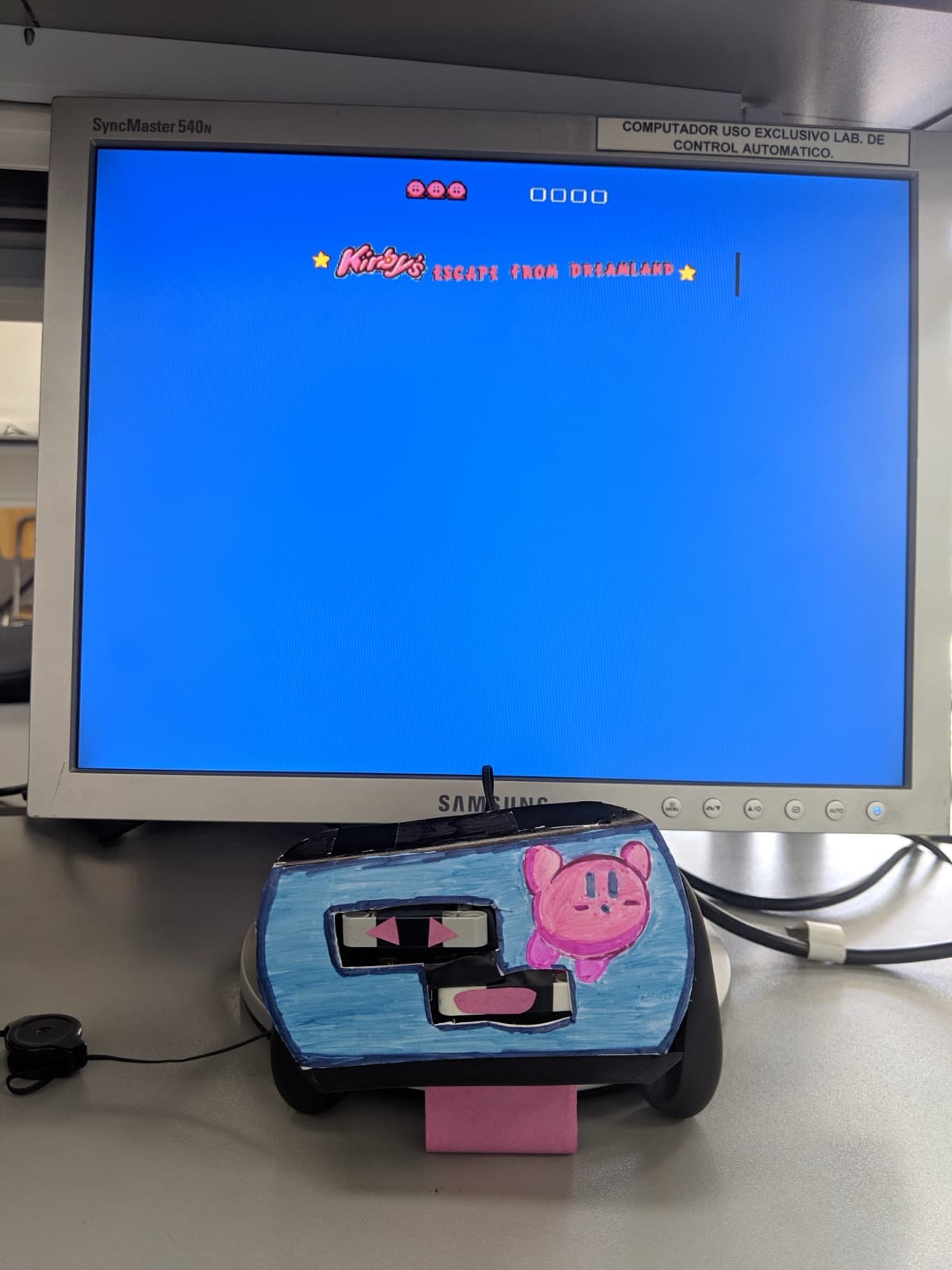 The Kirby-painted controller next to the title screen