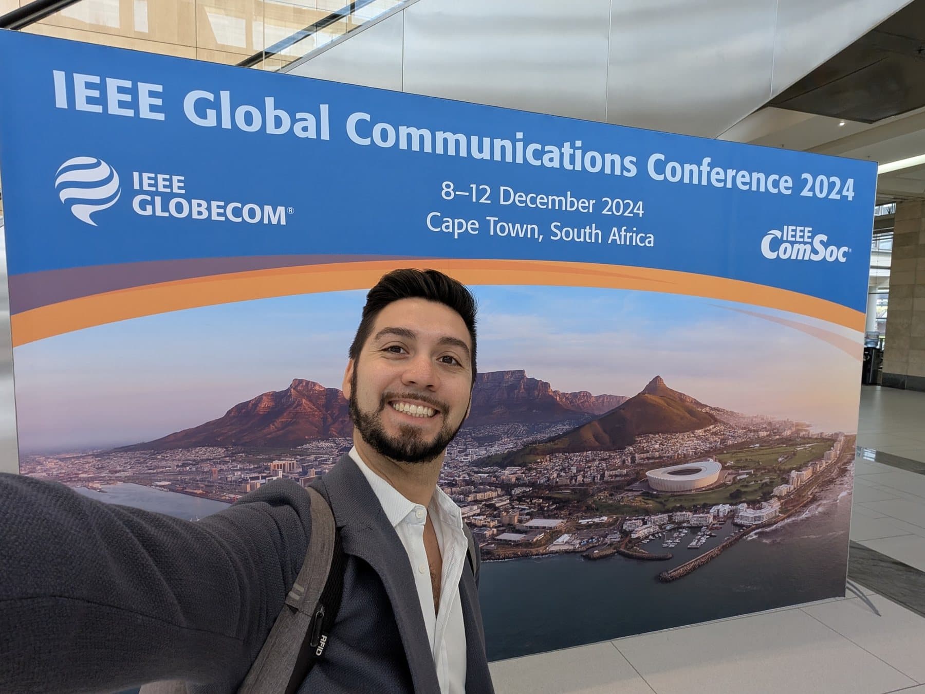 Selfie in front of the IEEE Globecom 2024 banner in Cape Town