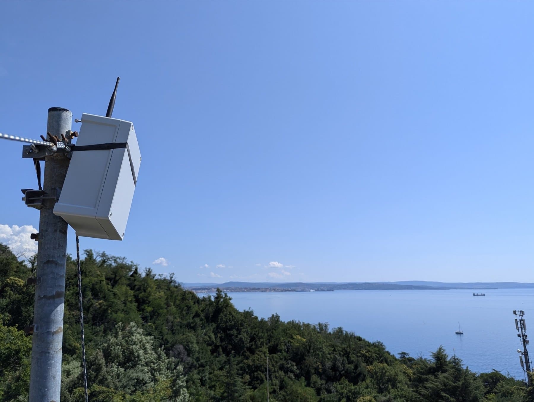 An AlLoRa node on a pole at ICTP, above the coast of Trieste
