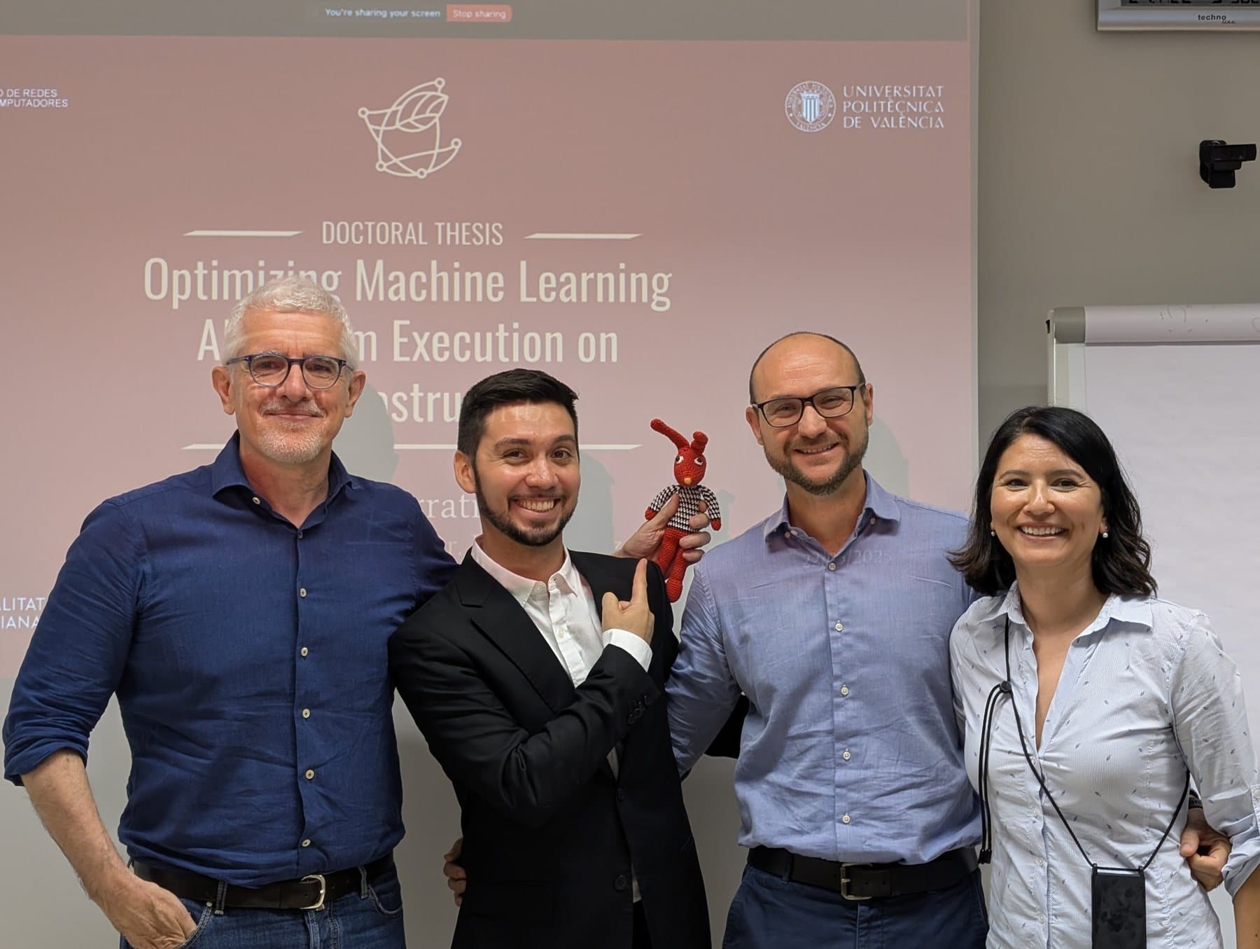 With Pietro Manzoni, José María Cecilia and Erika Rosas in front of the title slide, after my thesis defense at UPV
