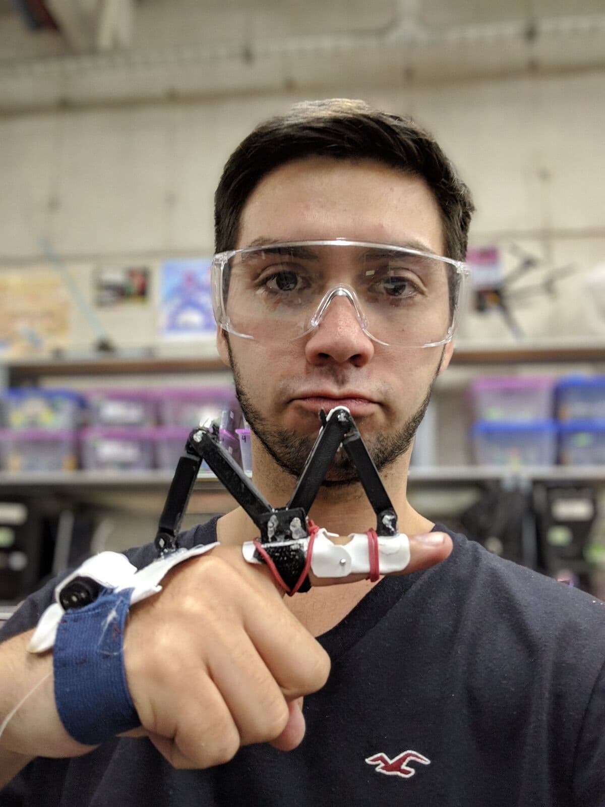 In the lab, wearing a printed exoskeleton prototype on one finger